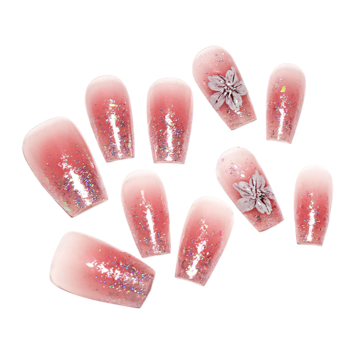 Künstliche Nagelverlängerungen mit floralem Design und Glitzerakzenten Karnz
