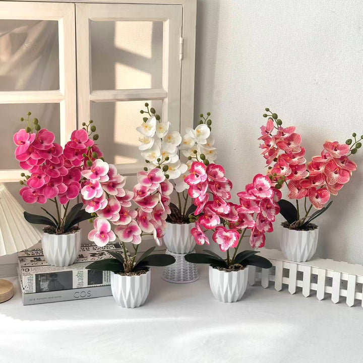 Dekoratives künstliches Orchideenarrangement für die Innendekoration zu Hause