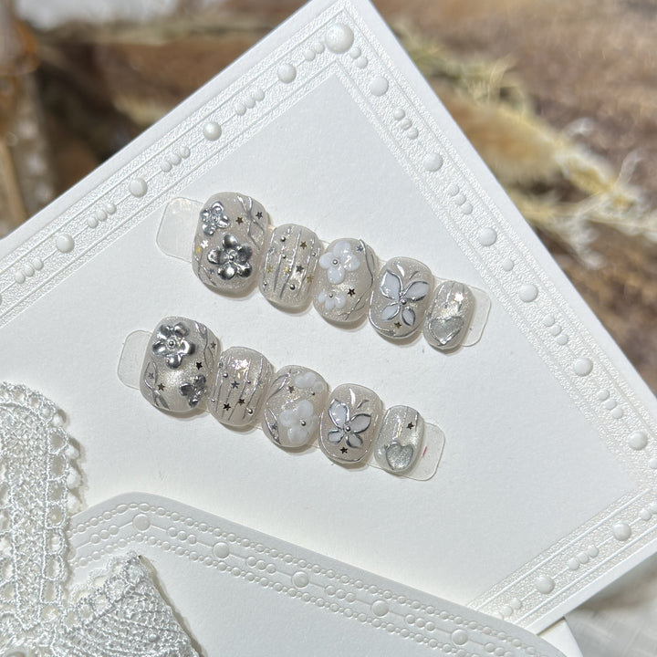 Dekoratives Press-On Nagelkunst Set mit floralen und Sternakzenten Karnz