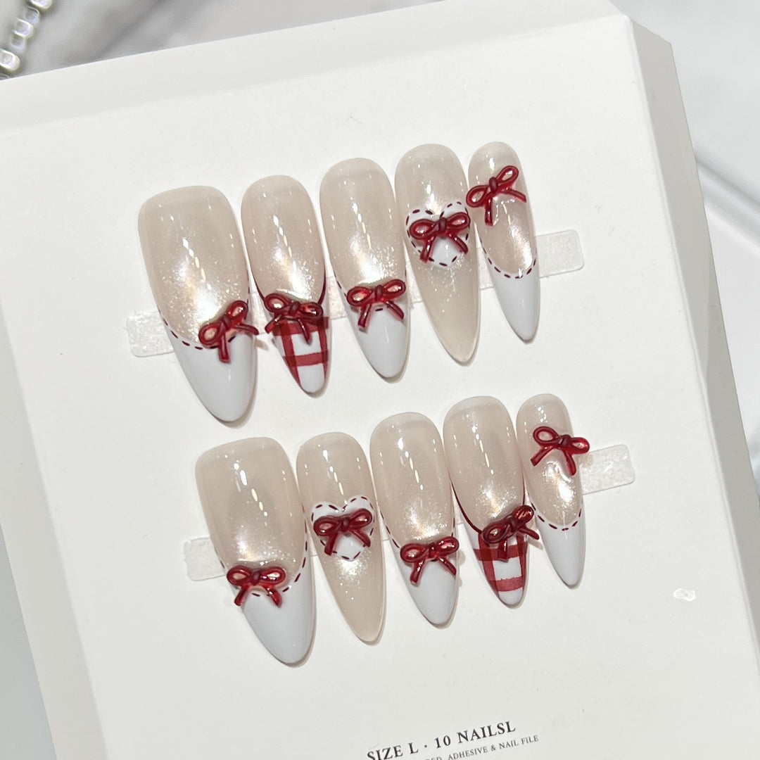 Dekorativer Stiletto Press-On Nagelset mit Schleifenakzenten Karnz