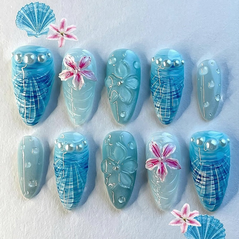 Kunstnagelset mit einzigartigen aquatischen Motiven und dekorativen Akzenten Karnz