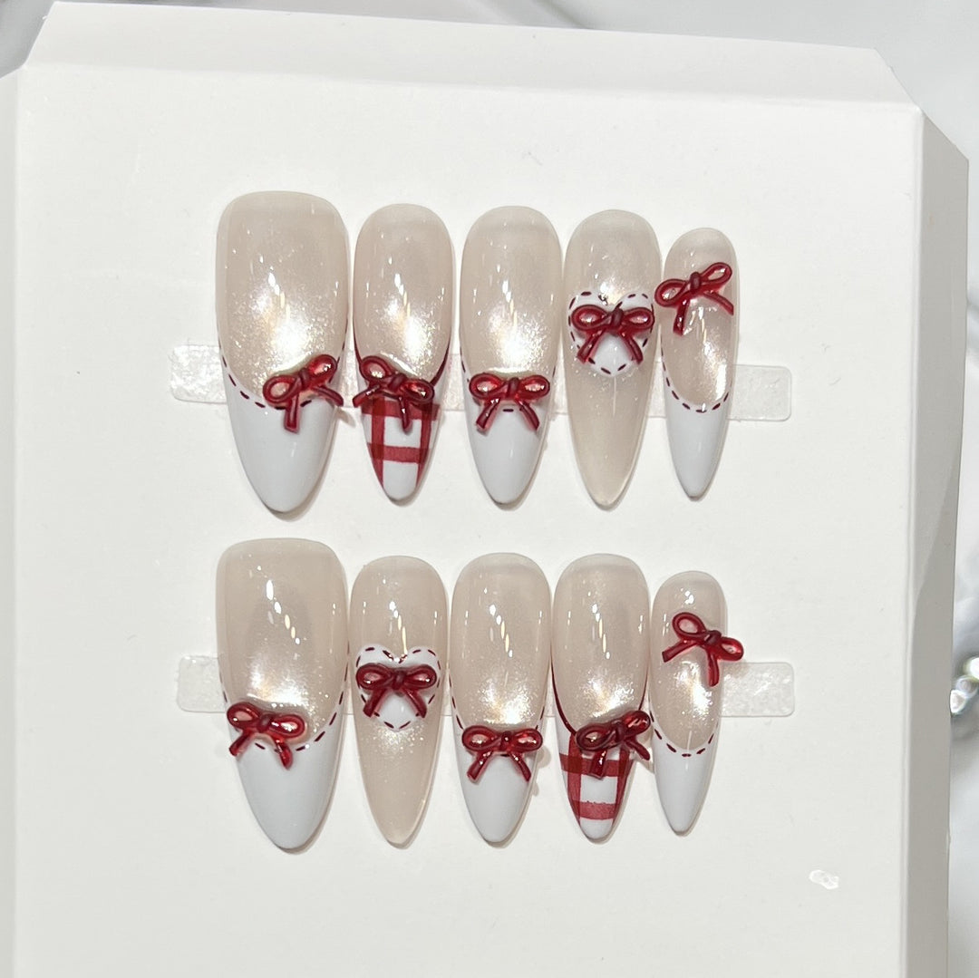 Dekorativer Stiletto Press-On Nagelset mit Schleifenakzenten Karnz