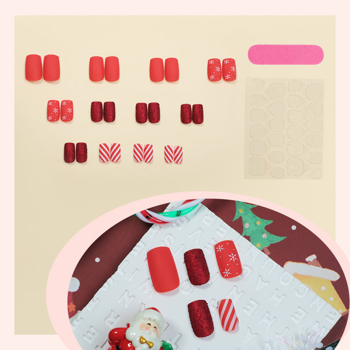 Kunstnagelset im festlichen Rot mit Glitzer- und Weihnachtsmotiven Karnz