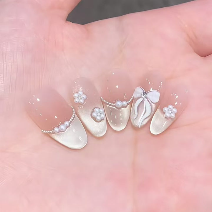 Künstlerisches Langes Stiletto Press-On Nagelset mit Schleife und Edelsteinakzenten Karnz
