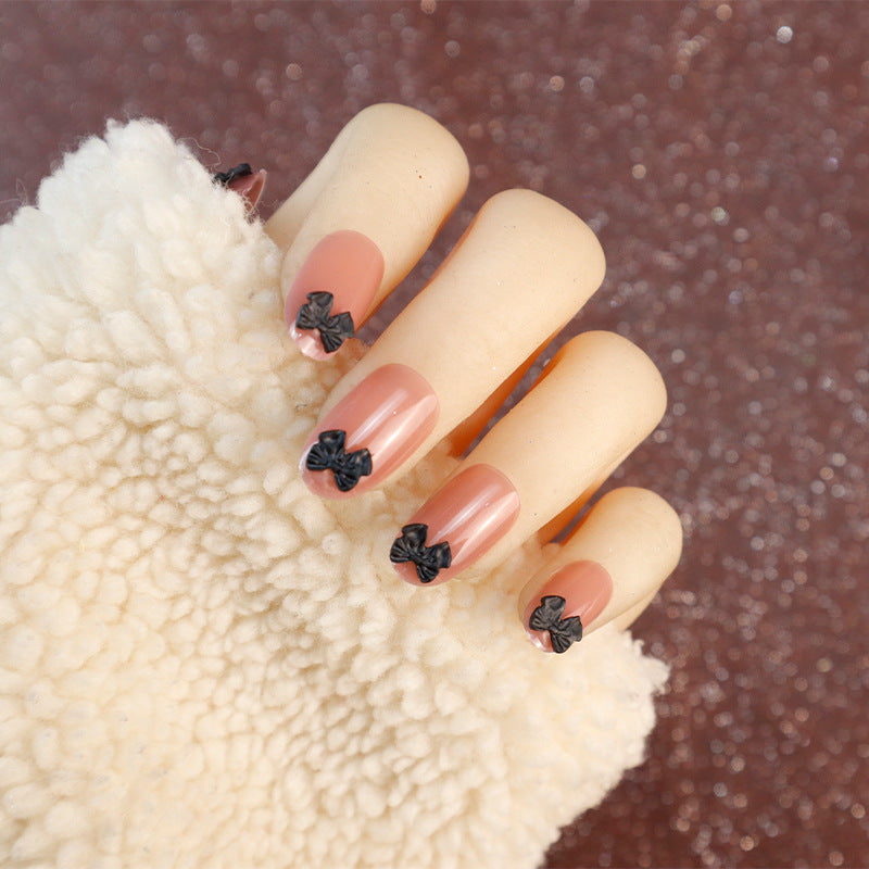 Dekorative Press-On Nagelset mit Schleifenakzenten