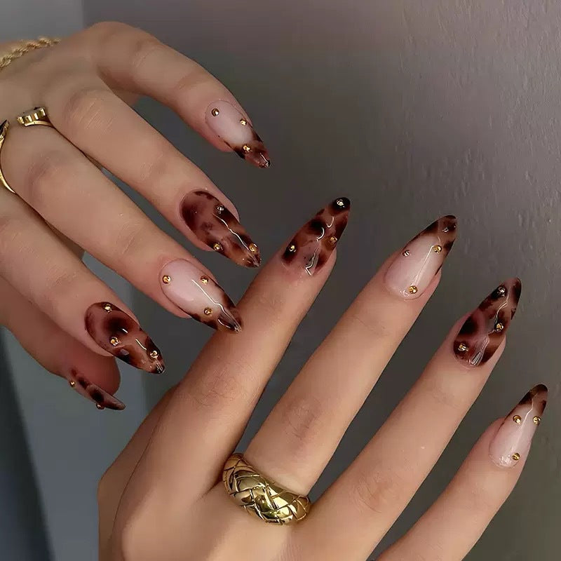 Kunstnagelset mit luxuriösem Leopardenmuster und goldenen Akzenten Karnz