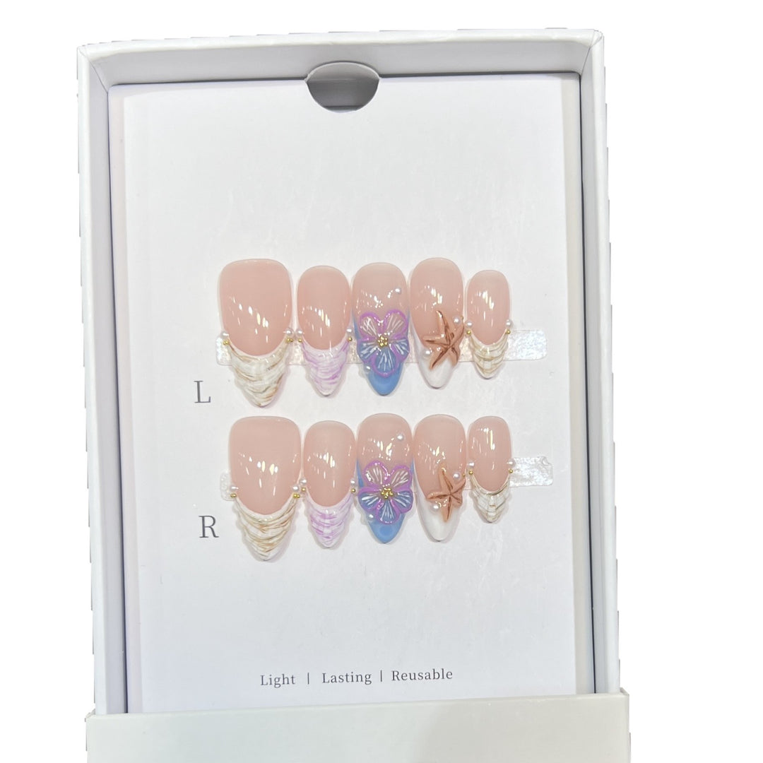 Künstlerisches Press-On Nagelkunst Set mit floralem und Seestern Design Karnz
