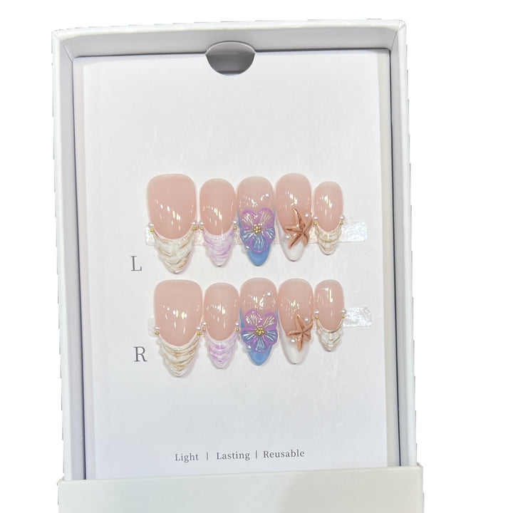 Künstlerisches Press-On Nagelkunst Set mit floralem und Seestern Design Karnz