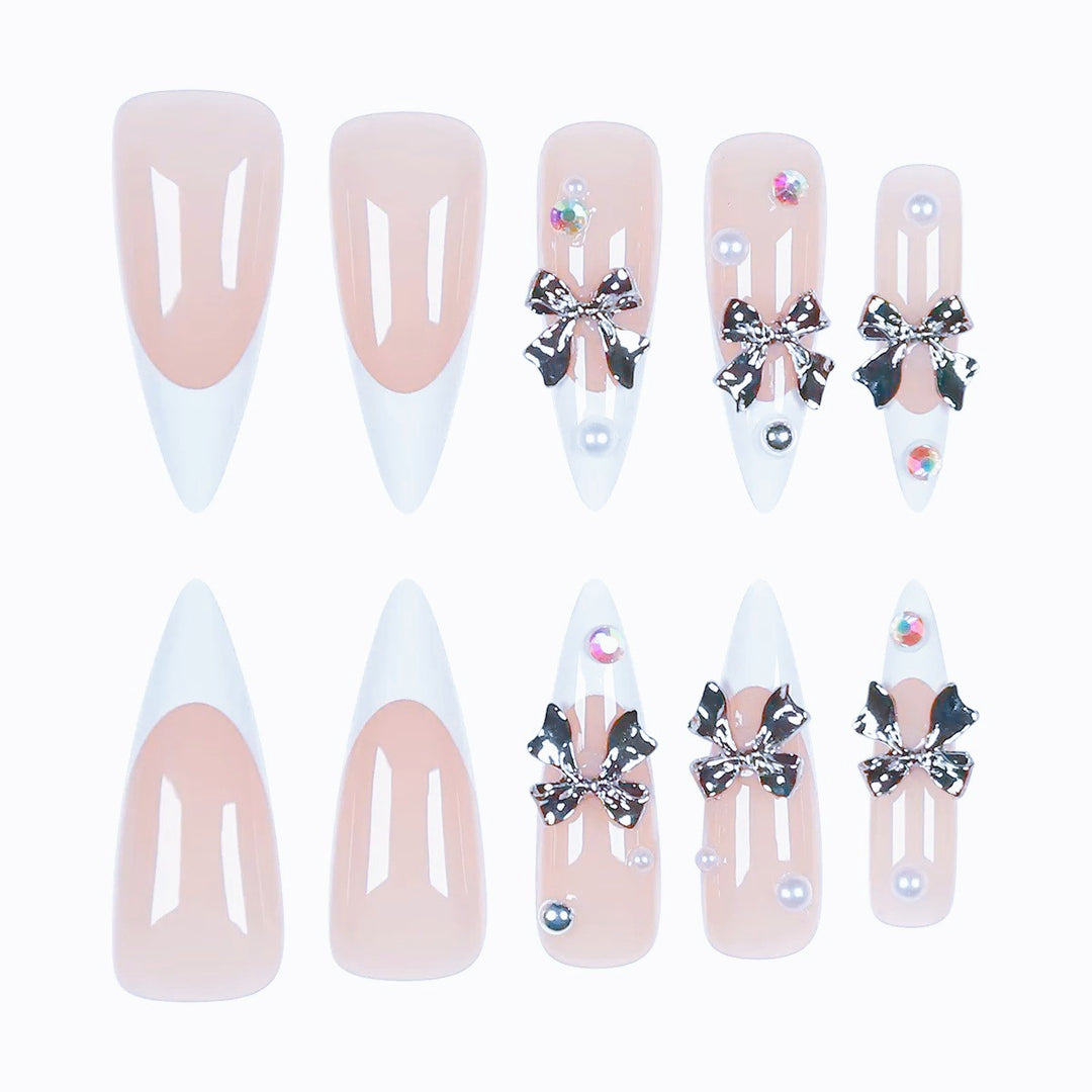 Kunstnagelset mit eleganten Schleifen und funkelnden Akzenten Karnz