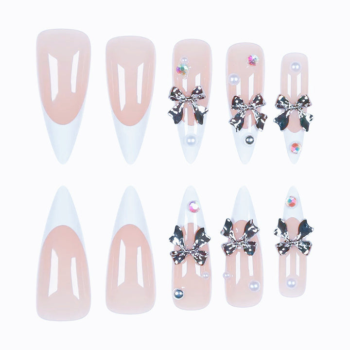 Kunstnagelset mit eleganten Schleifen und funkelnden Akzenten Karnz
