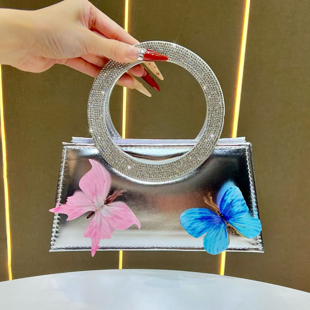 Künstlerische mit Schmetterlingen verzierte Handtasche