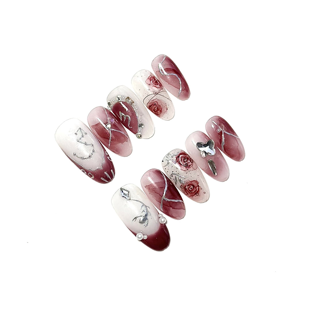 Künstlerisches Press-On-Nagelset mit floralen Designs und Steindekoren