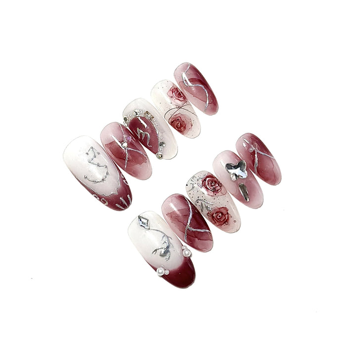 Künstlerisches Press-On-Nagelset mit floralen Designs und Steindekoren