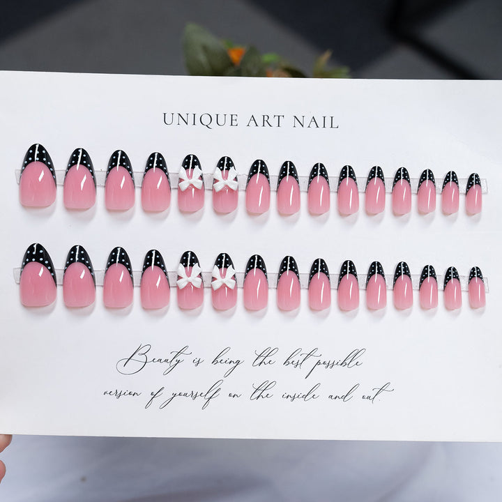 Dekorative Stiletto Press-On Nagelkunst mit Schleife und Punktmuster-Design