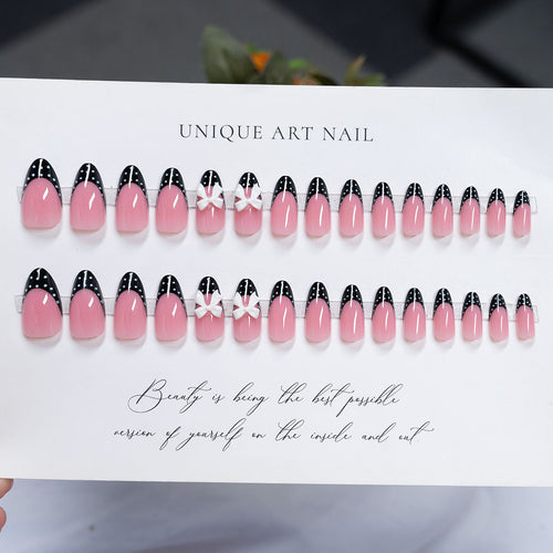 Dekorative Stiletto Press-On Nagelkunst mit Schleife und Punktmuster-Design