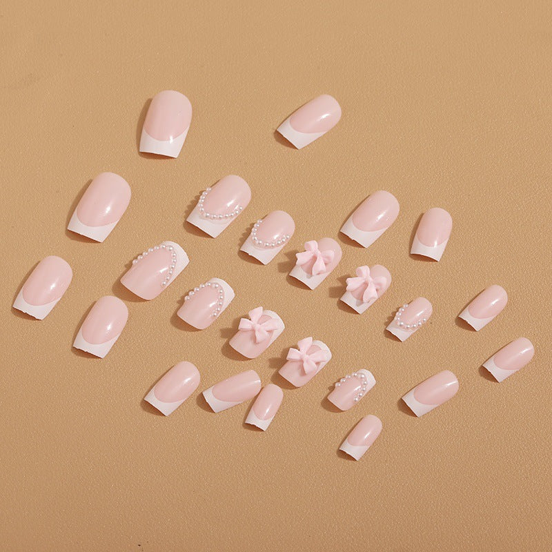 Künstliche Nagelspitzen mit eleganten Schleifen und Perlenverzierungen Karnz