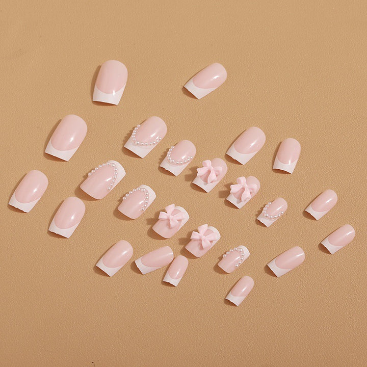 Künstliche Nagelspitzen mit eleganten Schleifen und Perlenverzierungen Karnz