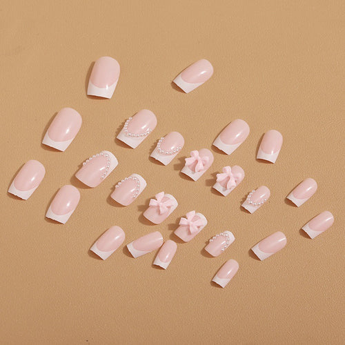 Künstliche Nagelspitzen mit eleganten Schleifen und Perlenverzierungen Karnz