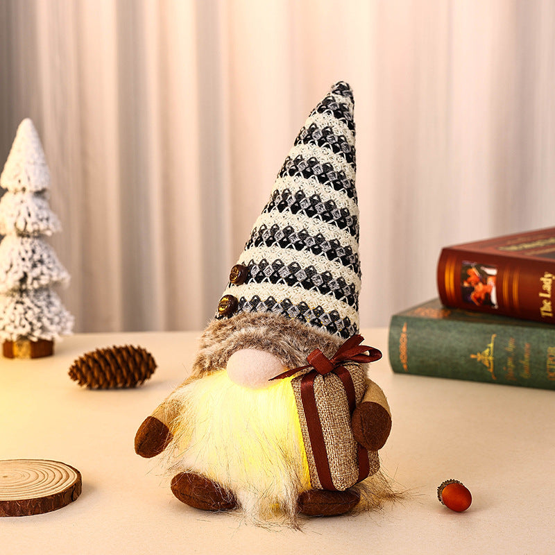 Dekorativer Weihnachtsgnom mit Geschenkpäckchen Karnz