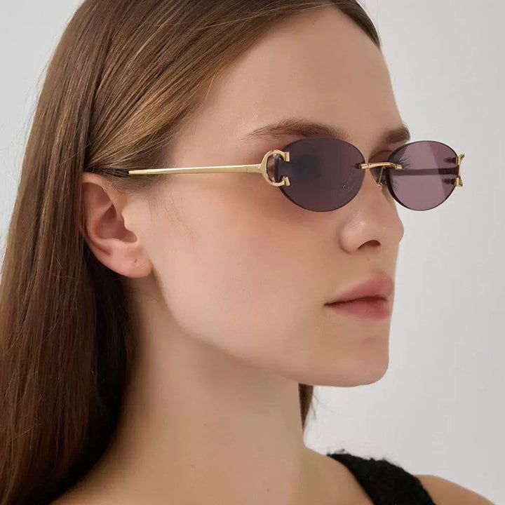 Damen elegante ovalförmige Sonnenbrille mit modischem Metallrahmen Karnz