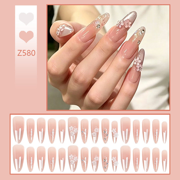Kunstnagelset mit floralen 3D-Applikationen und Glitzerakzenten Karnz